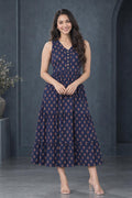 Woman wearing a floral tiered midi dress with a V-neckline and button-front detailing with heels.